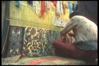 Man weaving Persian carpet in Iran