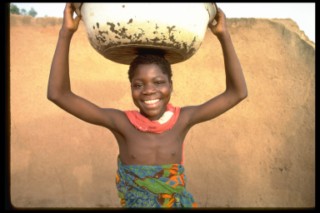 Girl carrying water basin in Bolgatanga, Ghana